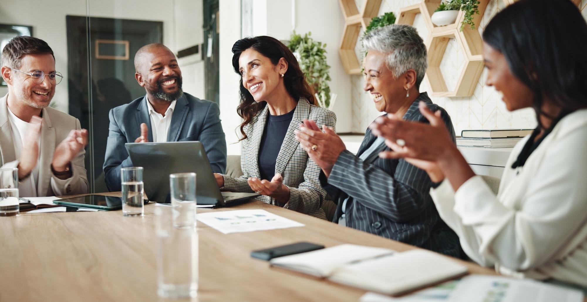 Diverse Canadian business professionals collaborating in a modern office, representing business financial planning and corporate strategies with GFI Canada